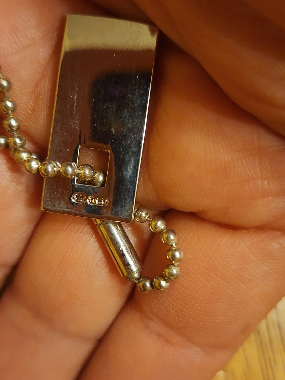 Gucci Sterling Silver Logo Tag likely used on a bracelet or keychain